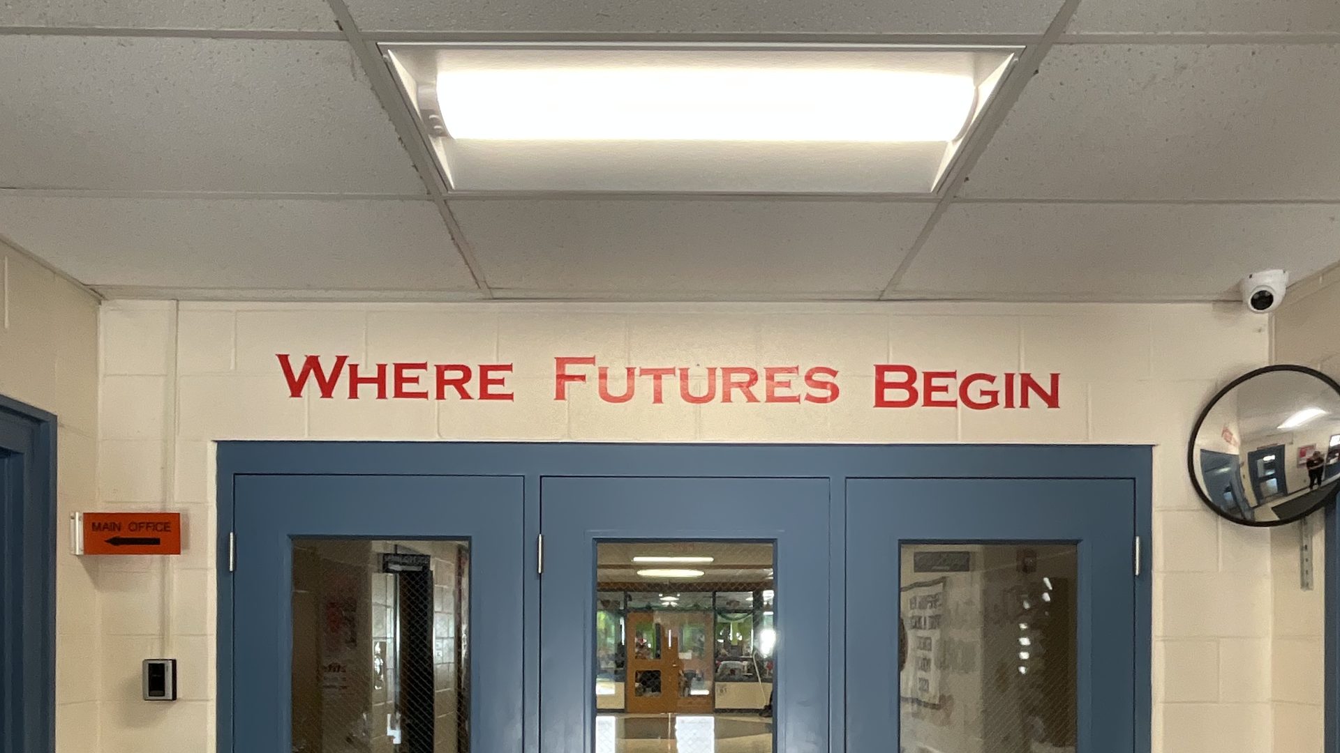 Chester Academy entrance under an LED ceiling panel, with Where Futures Begin lettered above the doors, Chester, NH