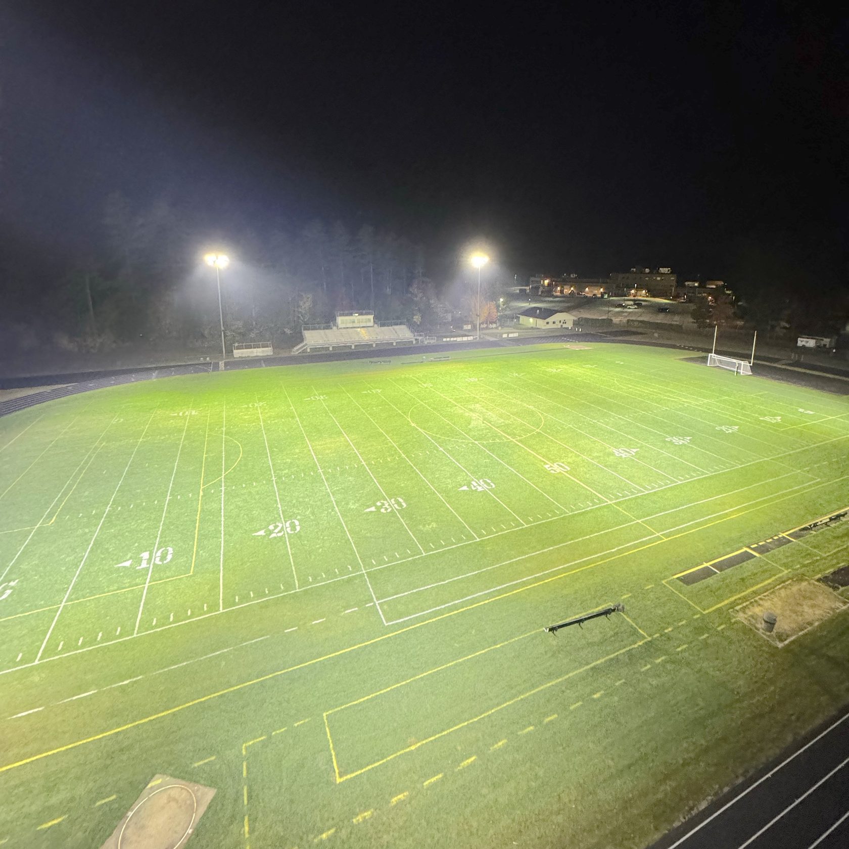Kennett High School field seen from above, evenly lit by LED sports lighting at night, Conway, NH