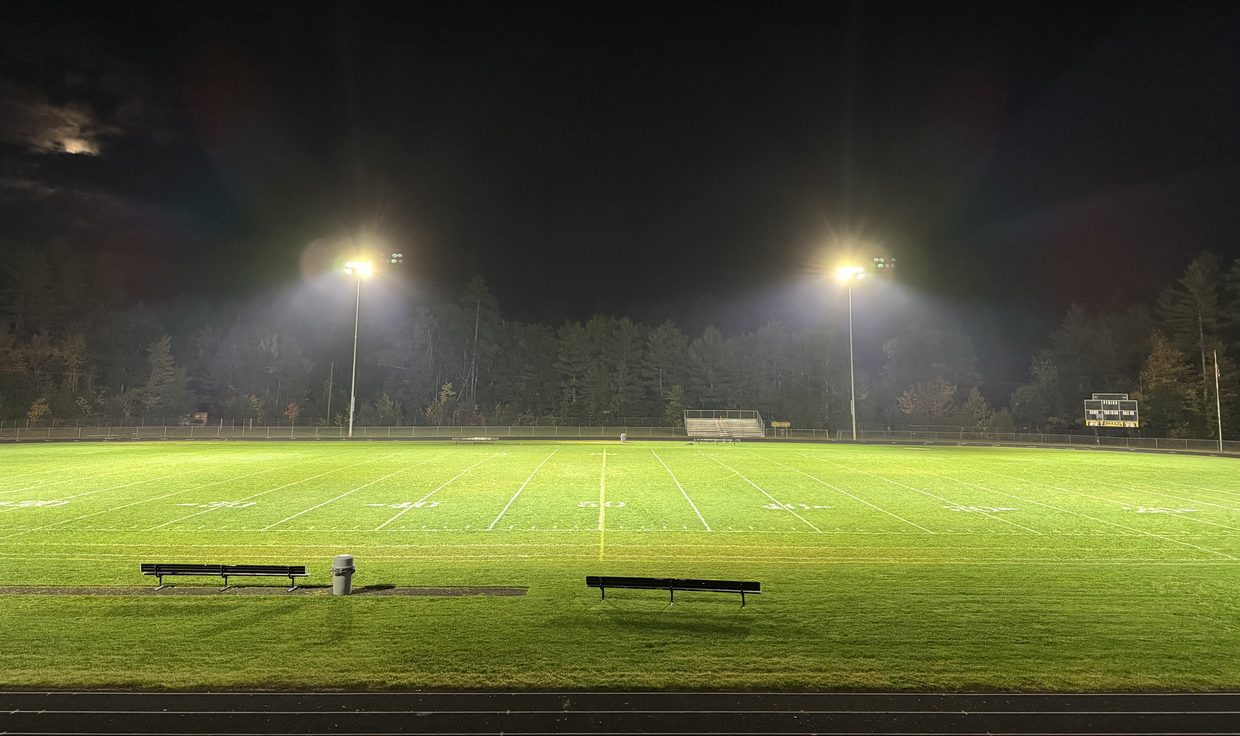 Kennett High School field at night under two poles of LED sports lighting, Conway, NH