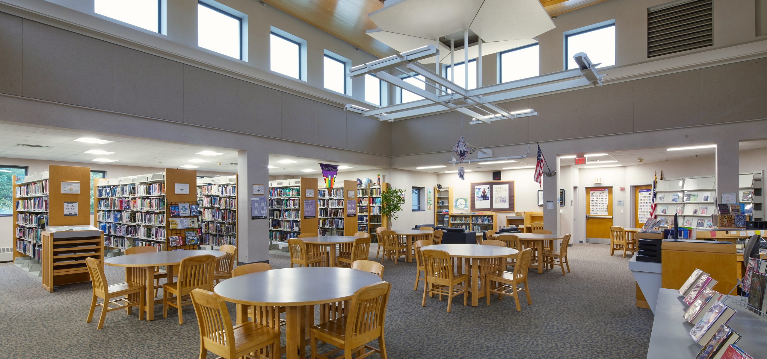 Marshwood High School library with a wood clerestory ceiling and suspended fixtures, South Berwick, ME