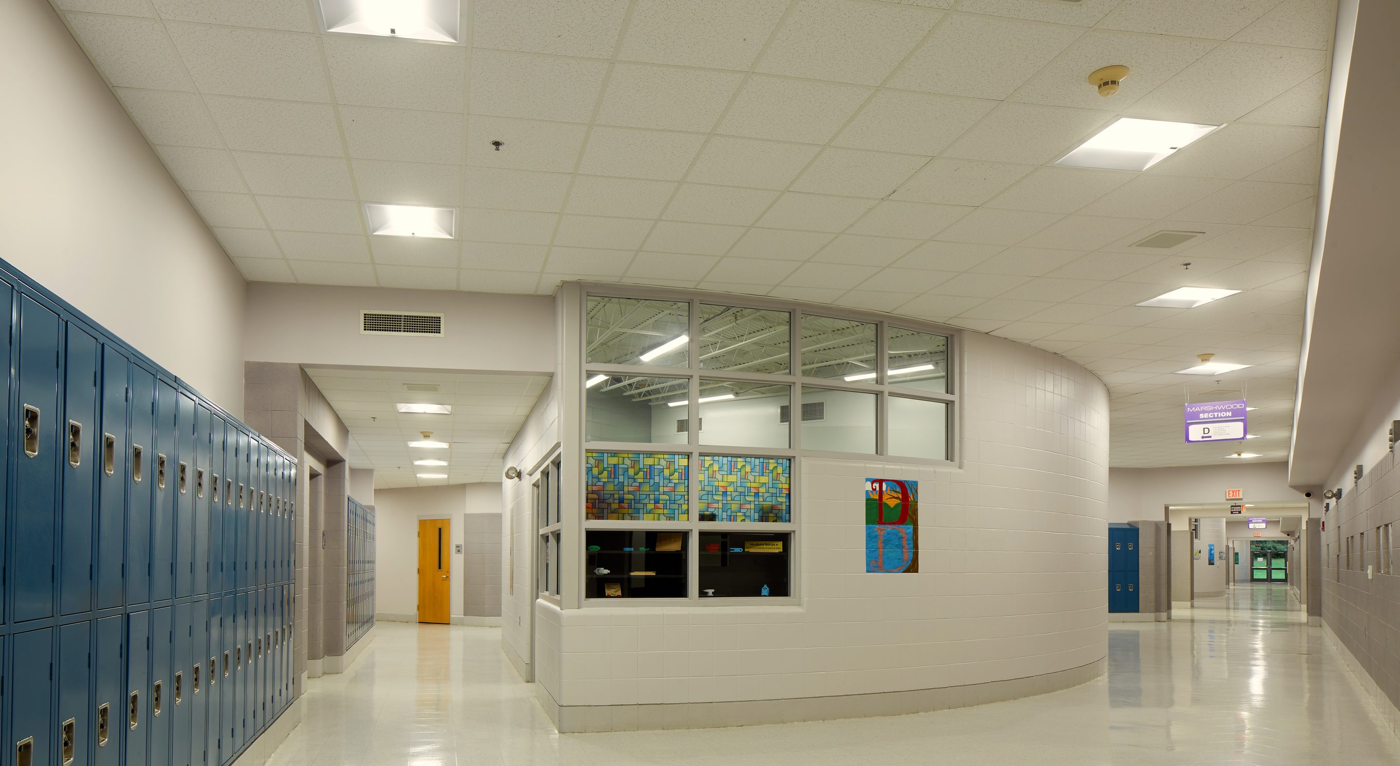 Marshwood High School hallway with blue lockers under LED troffers, South Berwick, ME
