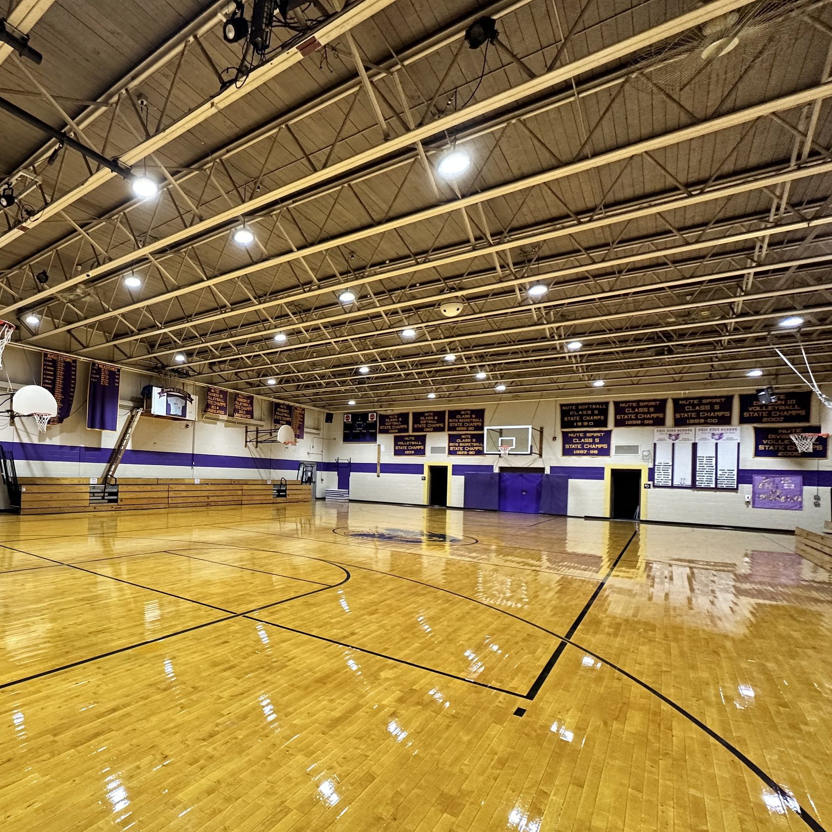 Empty Nute High School gymnasium under LED high-bay fixtures, Milton, NH