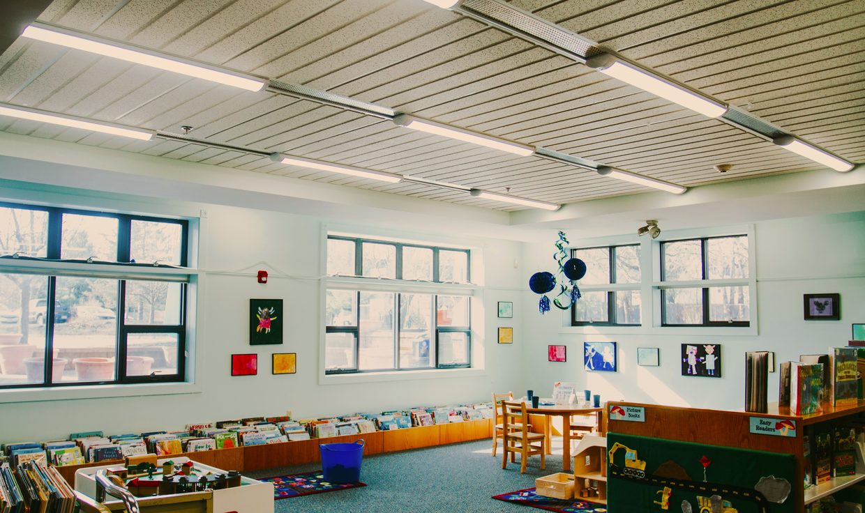 Children's reading room at the Rochester Public Library under suspended linear LED fixtures, Rochester, NH