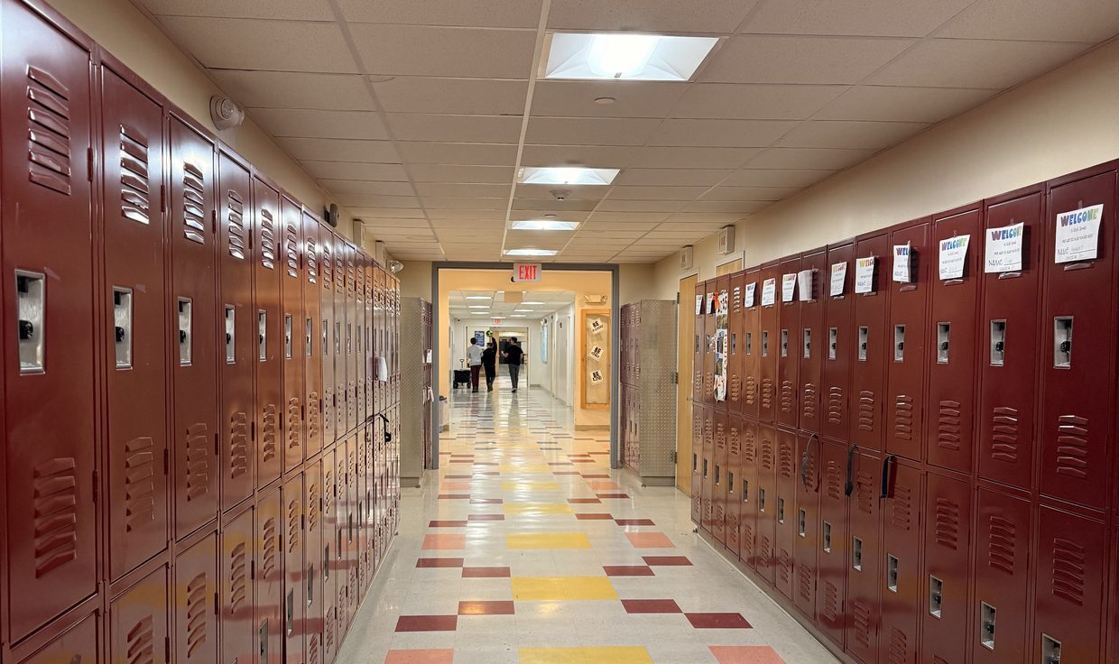 Hallway with maroon lockers at Skowhegan Middle School under LED troffers, Skowhegan, ME