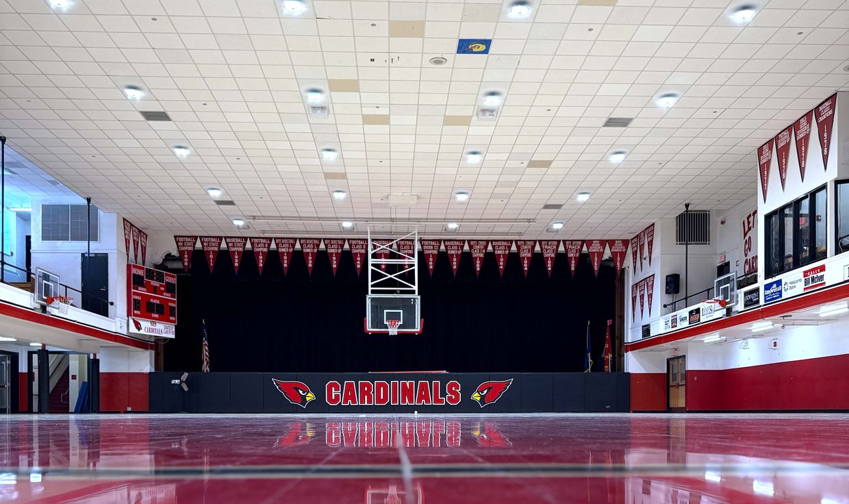 Stevens High School gymnasium with LED downlights reflected in the polished court, Claremont, NH