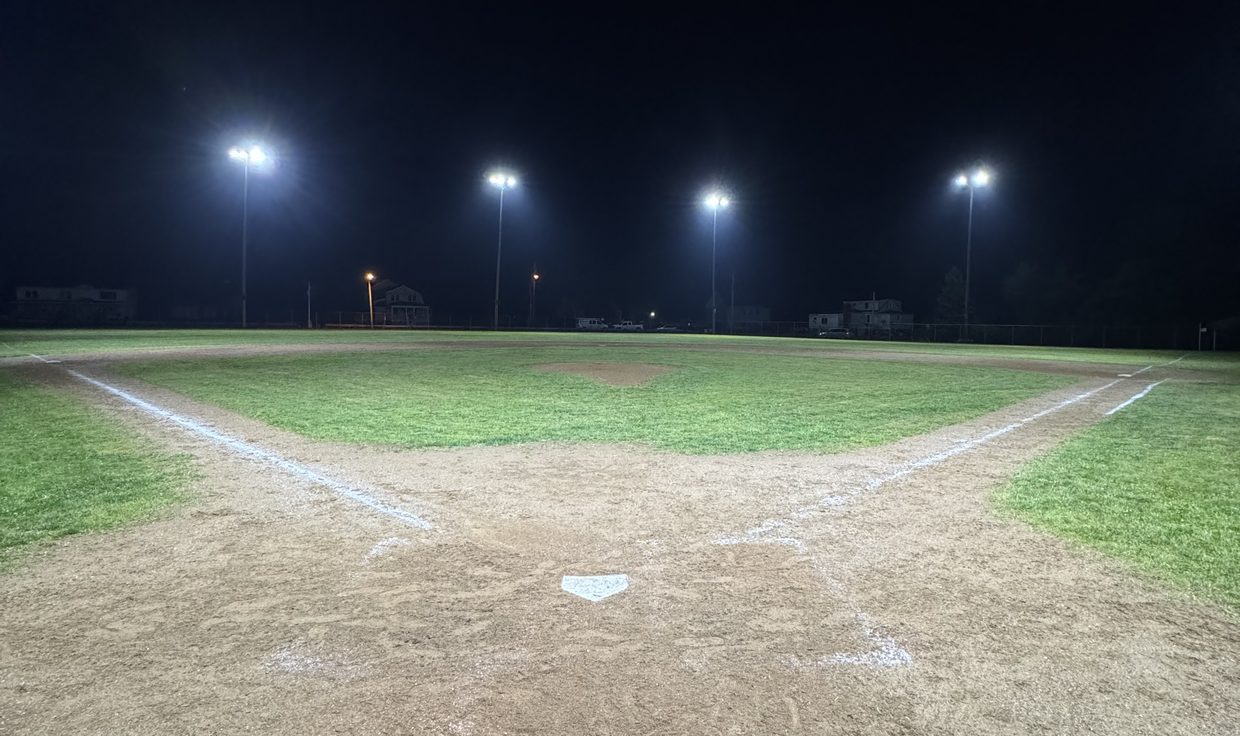 Baseball diamond at Veterans Memorial Park lit by four LED sports-light poles at night, Seabrook, NH