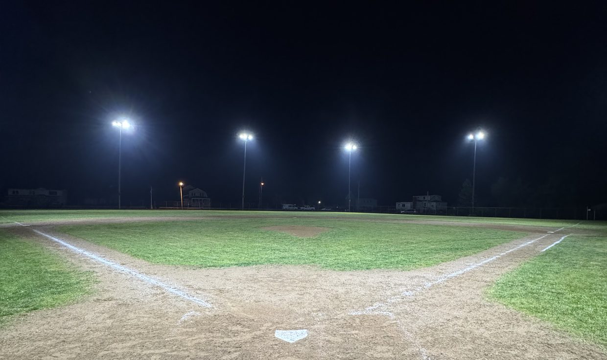 Baseball diamond at Veterans Memorial Park lit by four LED sports-light poles at night, Seabrook, NH