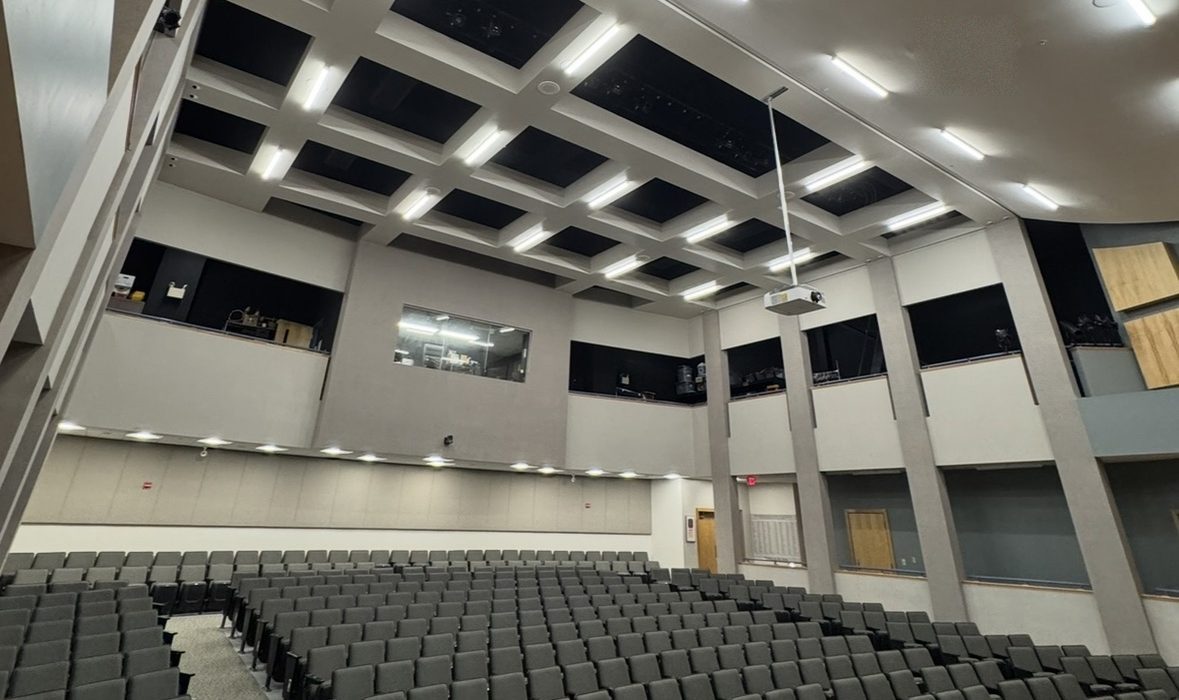 Vinalhaven School auditorium with linear LED fixtures in a coffered ceiling, Vinalhaven, ME